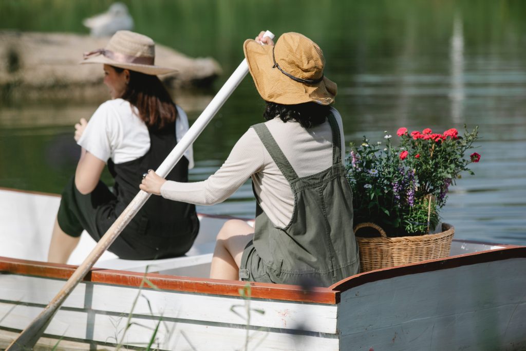 Image of girls in boat with flowers