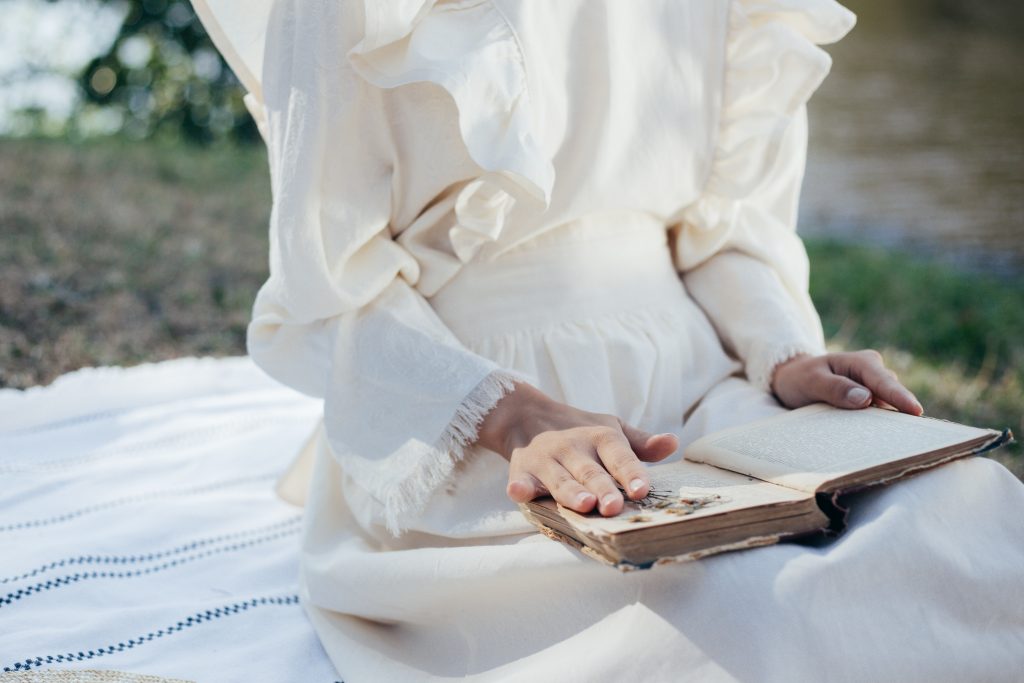 woman reading book on picnic